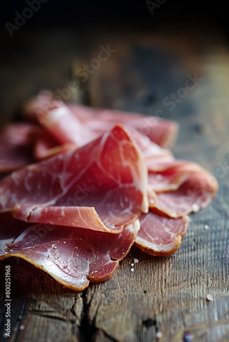 Display of artfully cut cured ham slices arranged on vintage wooden table for rustic charm