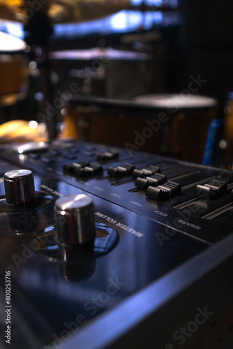 Close-up of a professional music mixer in the studio, selective focus. Vertical photo