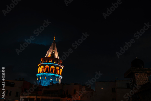 View of Galata Tower illuminated with lights at night in Istanbul, Turkey.