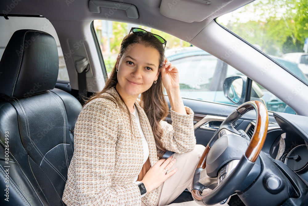 Portrait of young woman inside car interior. The car as a place in which a significant part of people lives passes