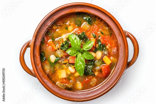 Minestrone soup in tarracotta bowl on white background photo