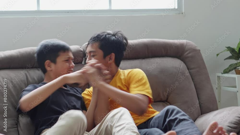 Young Boy Fight Over Remote Control From His Brother, Spending Time on Weekend by Watching TV Together at Home. Young Boy Fight Over Remote Control From His Brother, Spending Time on Weekend by Watching TV Together at Home.