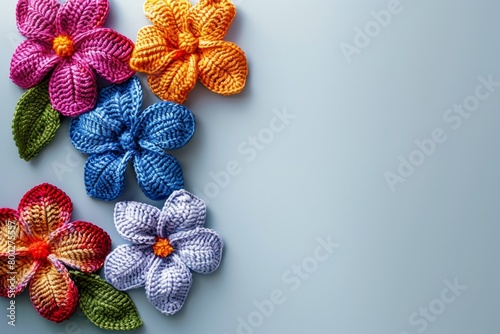 crochet colored flowers flat lay background. Copy space for text