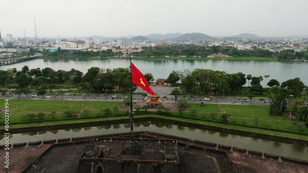 Drone shot of Vietnam's flag waving in the Imperial City of Hue and the Historic Citadel