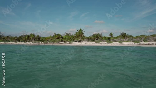 Tropical beach aerial reverse low level view over calm seas Xpu Ha, Mexico photo