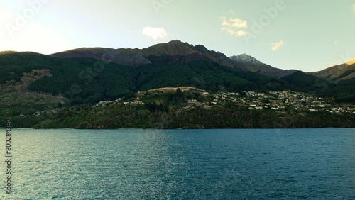 Wallpaper Mural Aerial frontal dolly establishes Queenstown New Zealand in shadow of mountains Torontodigital.ca