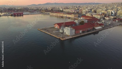 Sunrise Thessaloniki Waterfront: Aerial Drone Captures First Light at the Iconic Pier, Illuminating the Serene Aegean Sea – Vibrant Morning Colors Paint Greece's Coastal Cityscape Θεσσαλονίκη, Ελλάδα photo