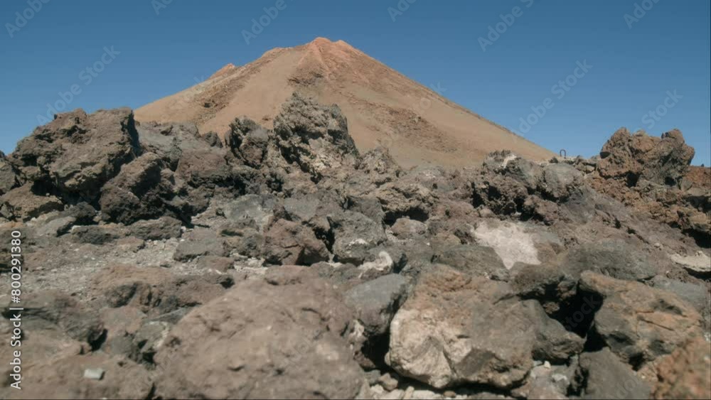 Volcanic peak of Pico del Teide behind rocks on Tenerife, Canary Islands in spring Volcanic peak of Pico del Teide behind rocks on Tenerife, Canary Islands in spring