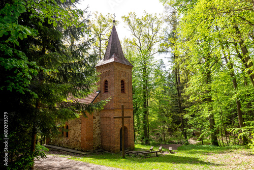 Old church with a wooden cross in the forest near Sobeslav. South Czechia.