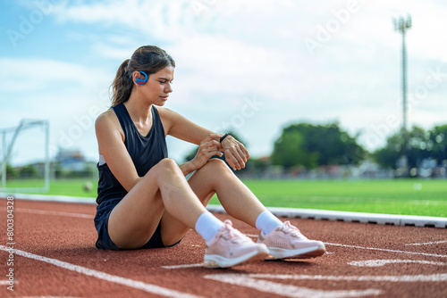 Beautiful Asian girl running at outdoor treadmill in sports stadium, Taking care of health and exercise for modern teenagers.