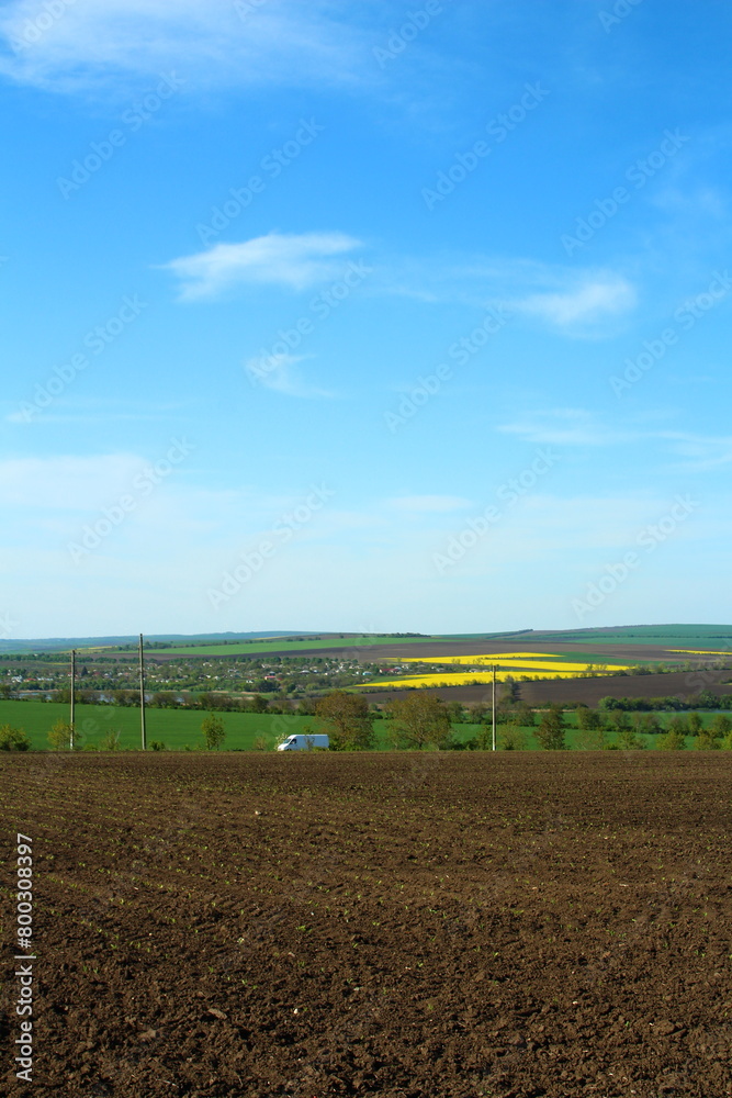 A field with a large field and a blue sky with clouds A field with a large field and a blue sky with clouds