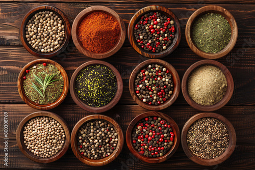assortment of differrent spices in little bowls over table background