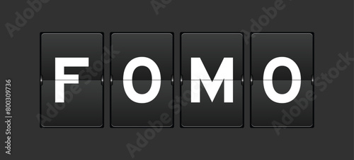 Black color analog flip board with word FOMO (abbreviation of fear of missing out) on gray background