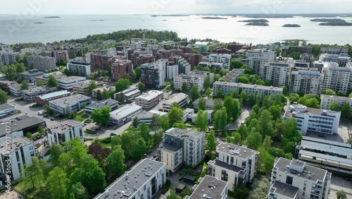 Aerial tracking shot overlooking condos in Drumso, spring in Helsinki, Finland photo