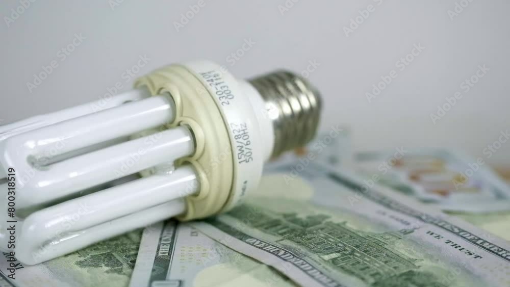 Light bulb rotate on 100 usd note bills Increase in electricity tariffs Light bulb rotate on 100 usd note bills Increase in electricity tariffs