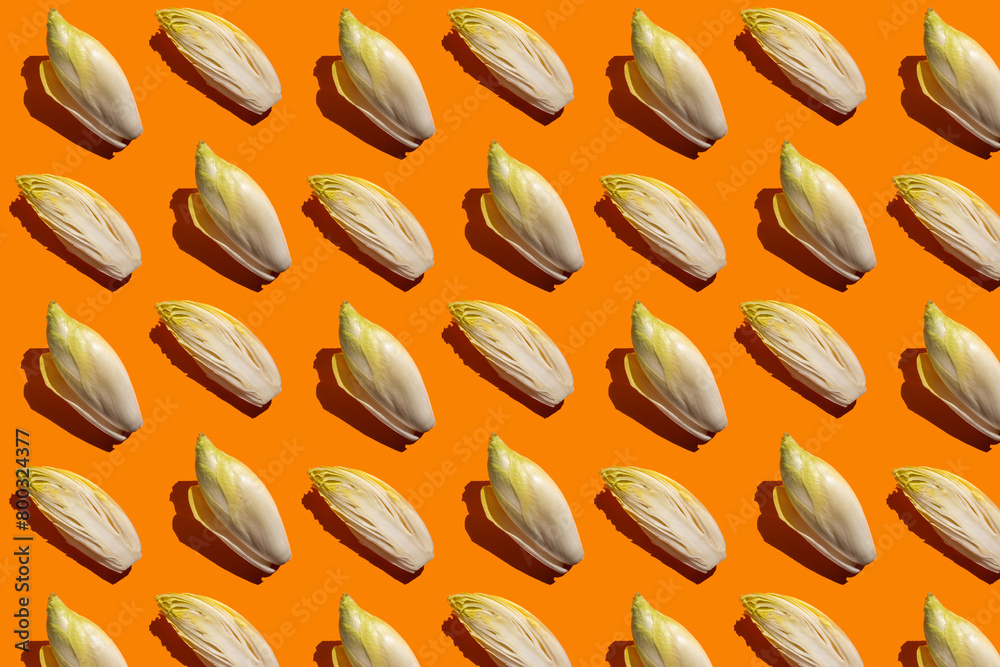 Creative layout of endives or witloof salad on bright background, isometric flat lay, minimalist pattern Creative layout of endives or witloof salad on bright background, isometric flat lay, minimalist pattern