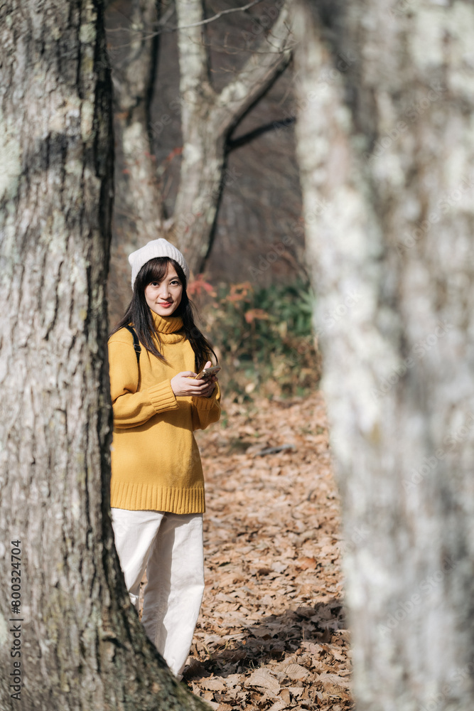 Immerse yourself in fall with a happy woman, enjoying nature and snapping selfies on her yellow smartphone. A blend of technology and the great outdoors. Immerse yourself in fall with a happy woman, enjoying nature and snapping selfies on her yellow smartphone. A blend of technology and the great outdoors.