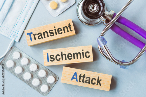 TIA or Transient Ischemic Attack Medical Concept Displayed on Wooden Blocks With Stethoscope and Medication