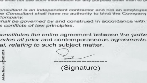 Signing an agreement. Signature on agreement paper. 4K photo
