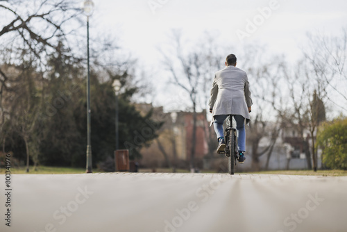 Man Riding Bike Down Brick Road In the Park