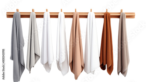 Colorful towels in various hues hang from a wooden rack, swaying gently in the air on transparent background © FMSTUDIO