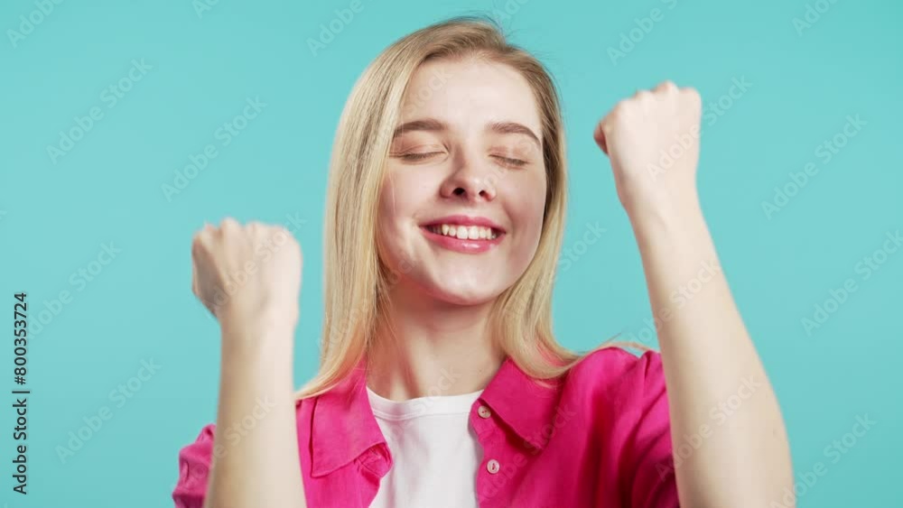 Young woman shows triumph yes gesture of victory, she achieved result, goals