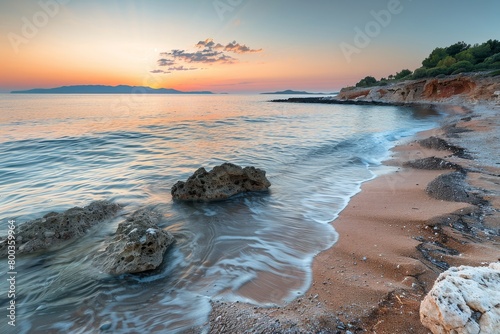 The ocean is calm and the sky is a beautiful orange color