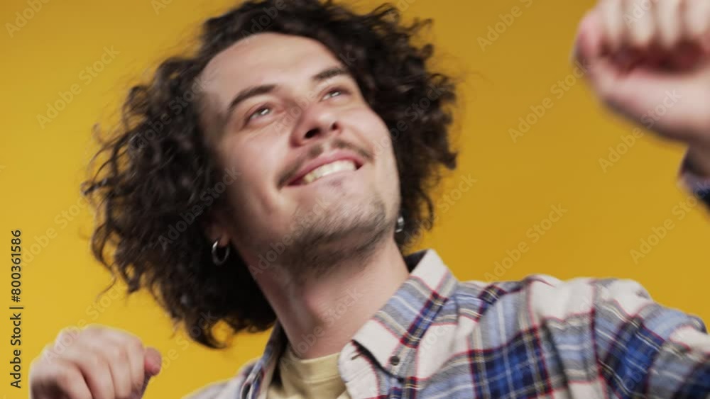Energetic happy man dancing, yellow background. Smiling hipster guy portrait. Energetic happy man dancing, yellow background. Smiling hipster guy portrait.