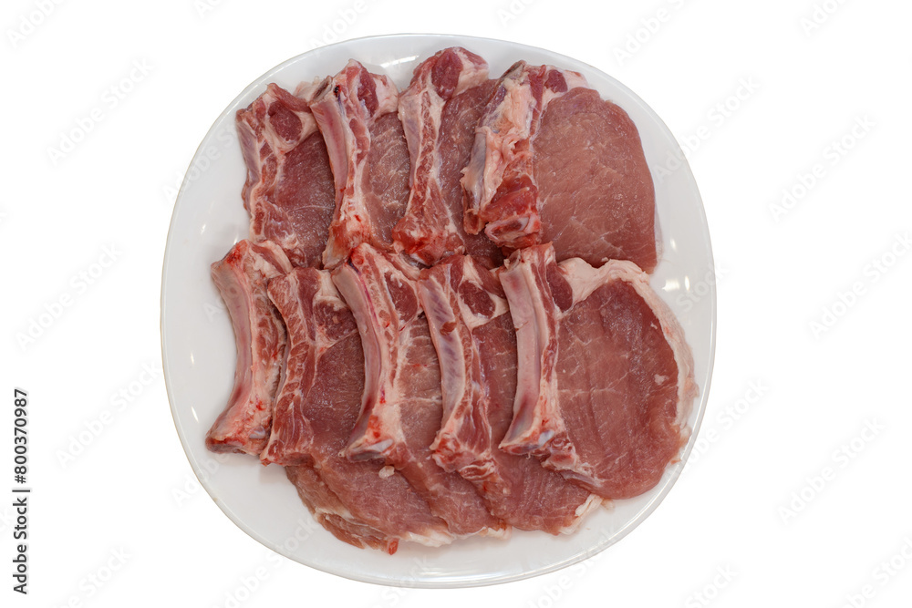 Fresh pork streaks on the plate on the white background
