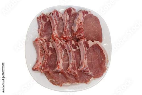 Fresh pork streaks on the plate on the white background