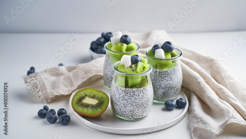 Chia pudding jars with kiwi and blueberries, a nutritious and colorful dessert setup