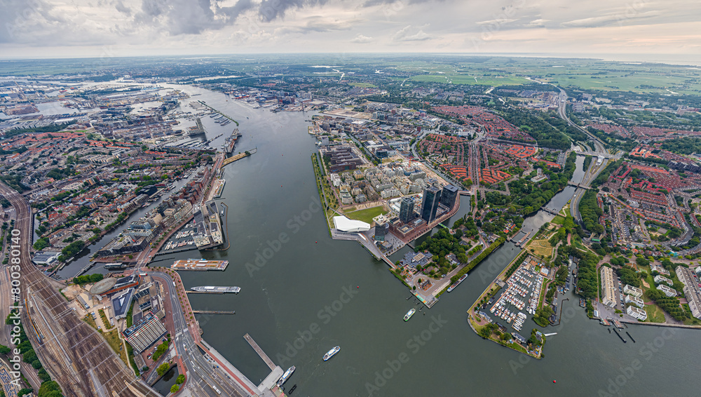 Amsterdam, Netherlands. Panorama of the city on a summer morning in cloudy weather. Aerial view