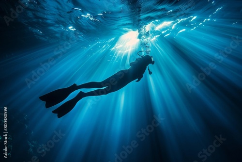 Submerged Diver Surrounded by Brilliant Blue Ocean Waters and Sun Rays - Adventure Tourism, Diving Excursions, Oceanic Studies