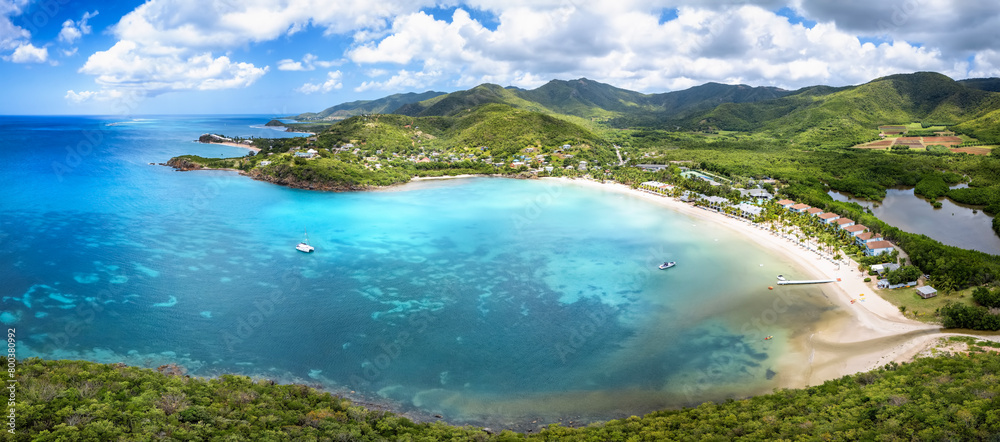 Panoramic aerial view of Carlisle Bay with lush rain forest and turquoise and emerald sea, Antigua and Barbuda, Caribbean