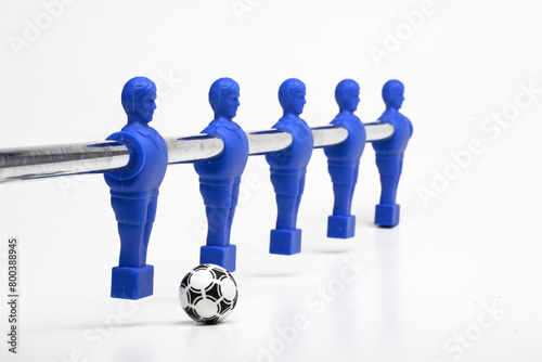 Foosball figures poised to kick the ball, (table soccer or table football)  on white background