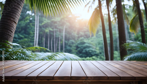 Wooden table top on blur green forest background with sun light.