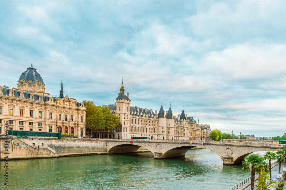 Conciergerie palace and Tribunal de Commerce de Paris with Pont au Change over Seine river in Paris, France. Building of former royal palace and prison. Palais de Justice and Commercial court