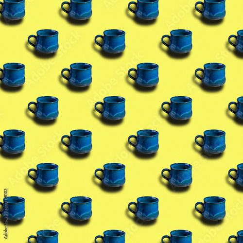 Repeating pattern of blue coffee cup on yellow background.