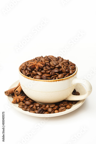 Cup with coffee beans and spices on white background. Space for a text