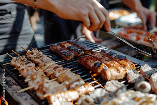 People grilling meat on a barbecue grill outdoors.