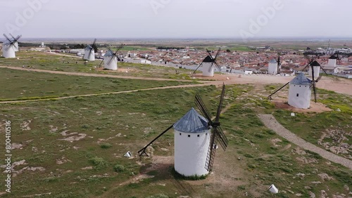 Aerial view of a group of windmills and residential neighborhoods in the city of Campo de Criptana, Spain. High quality 4k footage photo