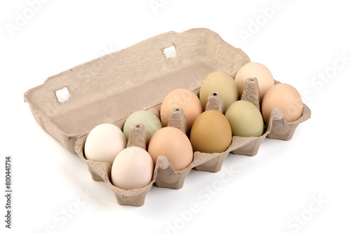Chicken eggs packed in cardboard tray, isolated on white background