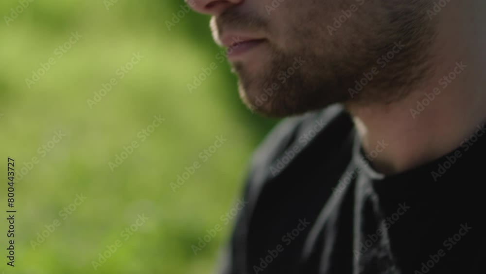Young man reading his Bible outside on a warm sunny day Young man reading his Bible outside on a warm sunny day