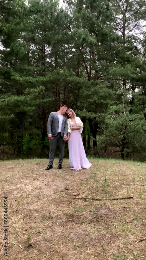 Happy couple, bride and groom turn to each other on their wedding day outdoors in the forest, amazing wedding moments in nature. vertical video Happy couple, bride and groom turn to each other on their wedding day outdoors in the forest, amazing wedding moments in nature. vertical video