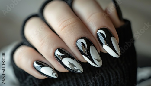 Closeup of black and white nail design on fingers  showcasing manicure