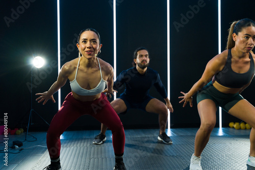 Dynamic group of people exercising and recording a fitness class