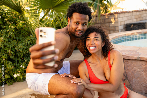 Two Adults Video Chat On The Phone From Poolside photo