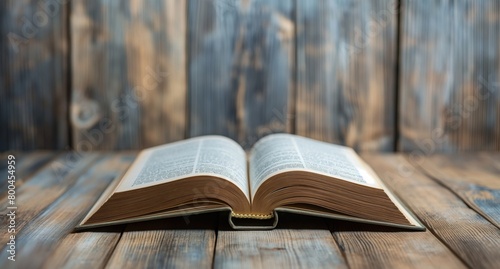 Close-up of an open book with turning pages against a rustic wooden background, capturing the timeless appeal of reading photo