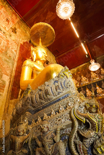 Phetchaburi Province,Thailand – 2nd April 2024: Big gold buddha statue in church at Wat Mahathat Worawihan Temple.Vertical. © surasak