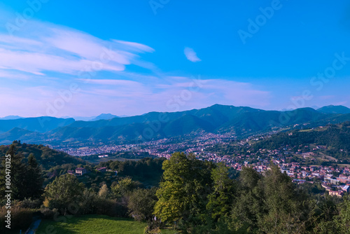 Aerial view of historic medieval walled city of Bergamo seen from Città Alta (Upper Town), Lombardy, Northern Italy, Europe. Alpine landscape of Italian Alps, historical buildings and the towers